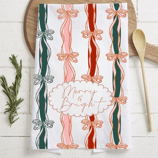 Decorative towel with candy cane and bow pattern on a wooden surface