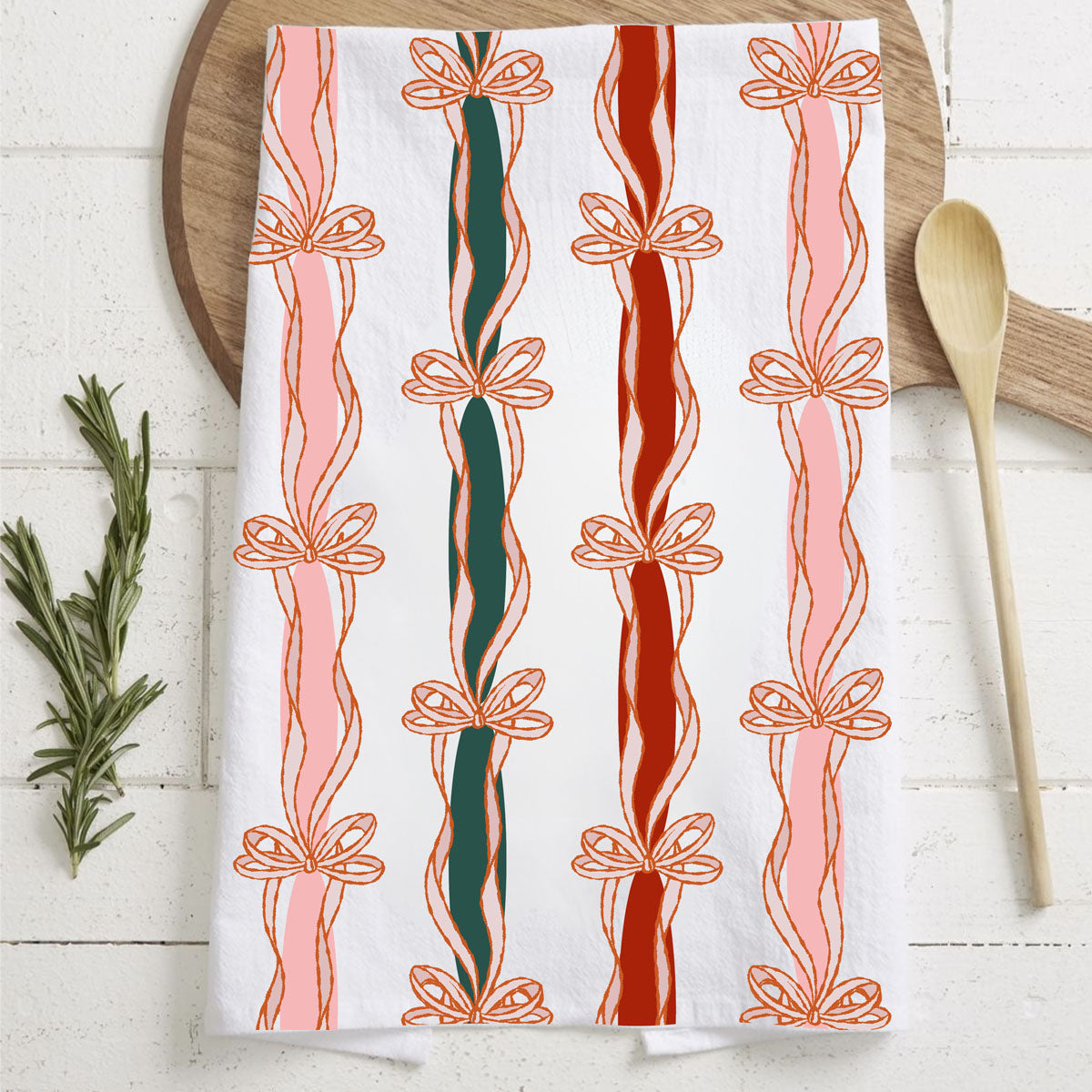 Decorative towel with candy cane and bow pattern on a wooden surface