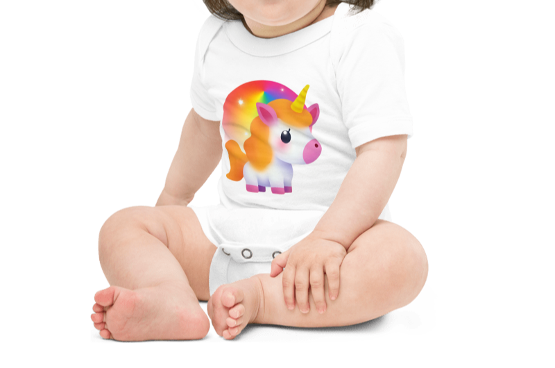Child wearing a white onesie with a colorful unicorn design on a white background