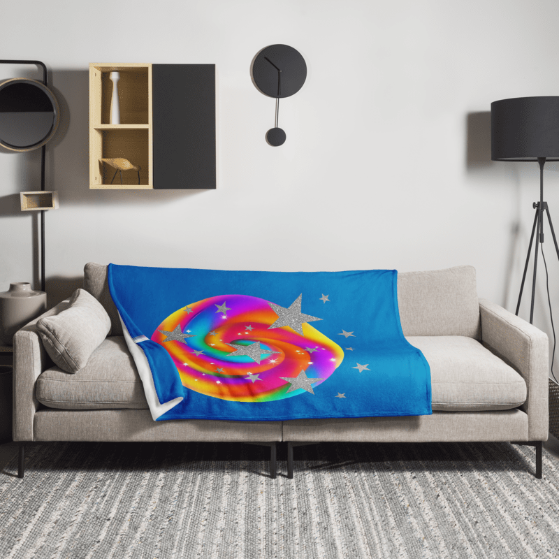 Colorful spiral design blanket on a gray sofa in a living room setting.