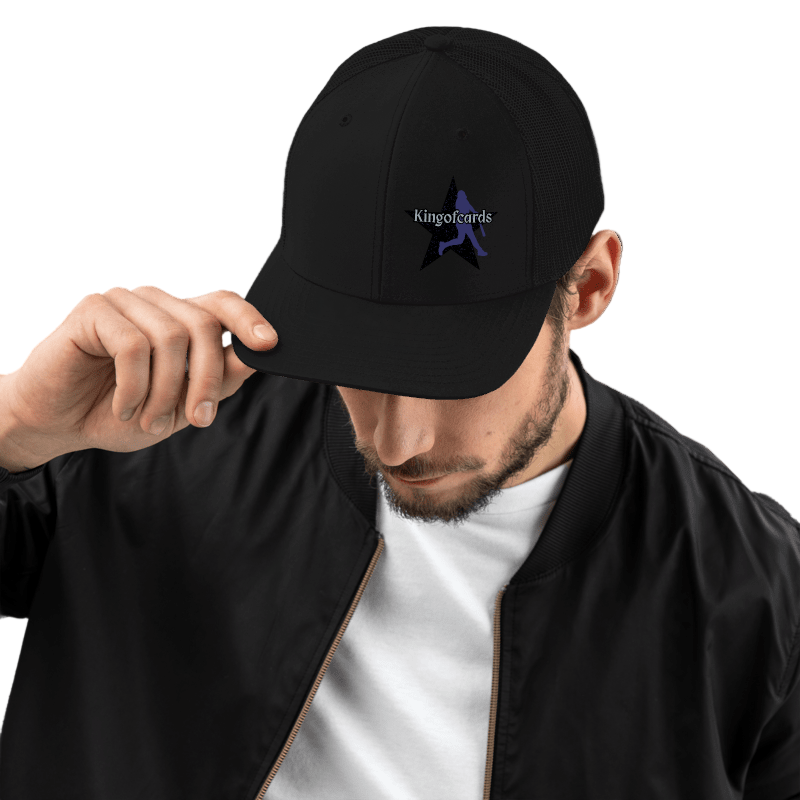 Man wearing a black cap with a logo, white shirt, and black jacket on a white background