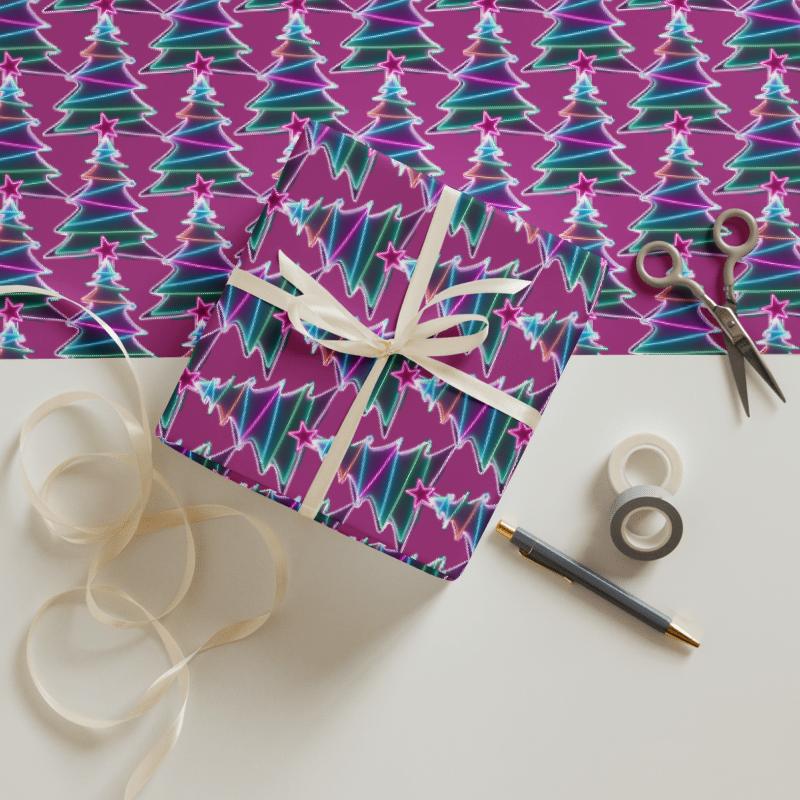 Gift box wrapped in purple paper with Christmas tree pattern, ribbon, scissors, and tape on a white background
