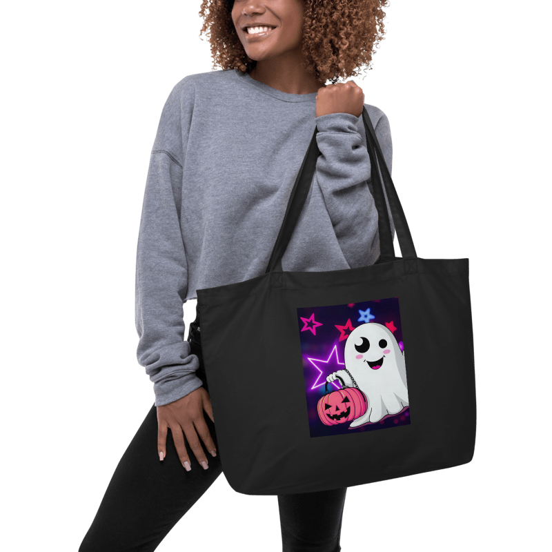 Person holding a black tote bag with a Halloween-themed ghost design.