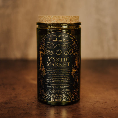 Jar of 'Mystic Market' candle by Phantom Row on a wooden surface with a blurred background