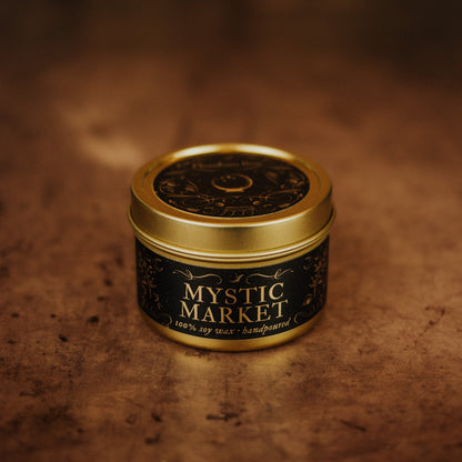 Mystic Market candle in a gold tin on a textured brown background