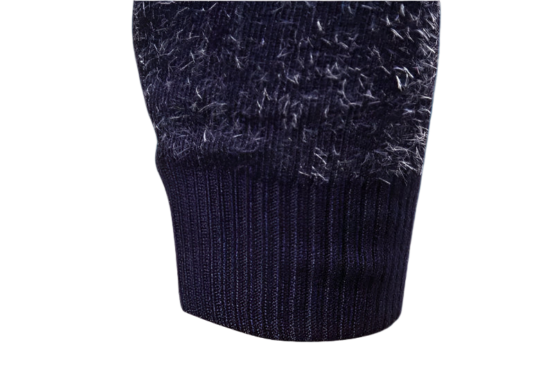 Close-up of a dark blue knitted sweater with textured pattern on a white background