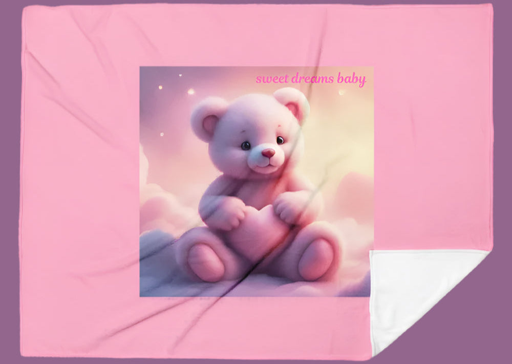 Pink blanket with a teddy bear design and 'sweet dreams baby' text on a white background