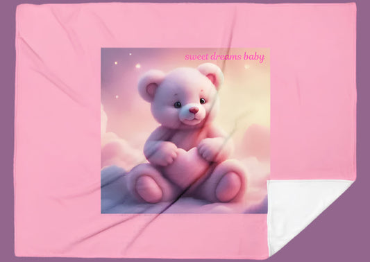 Pink blanket with a teddy bear design and 'sweet dreams baby' text on a white background