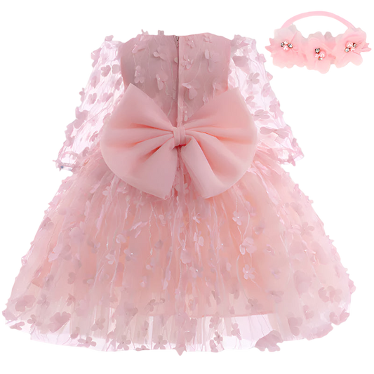 Pink lace dress with a large bow and matching headband on a white background