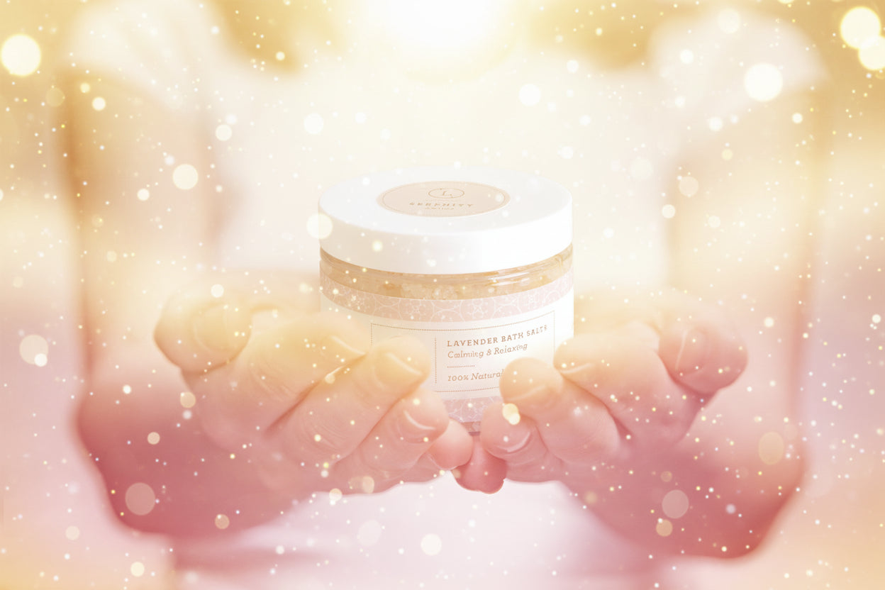 Person holding a jar of lavender bath salts with a blurred background