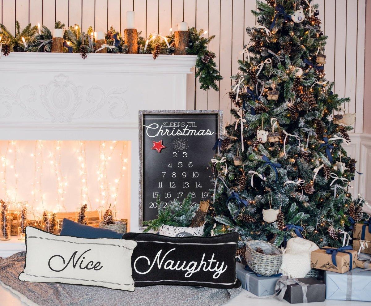 Decorated Christmas tree with a fireplace and 'Nice' and 'Naughty' signs.