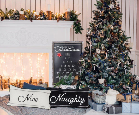 Decorated Christmas tree with a fireplace and 'Nice' and 'Naughty' signs.