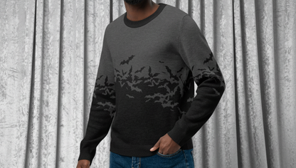 Man wearing a dark gray sweater with a gradient design, blue jeans, and white sneakers on a transparent background