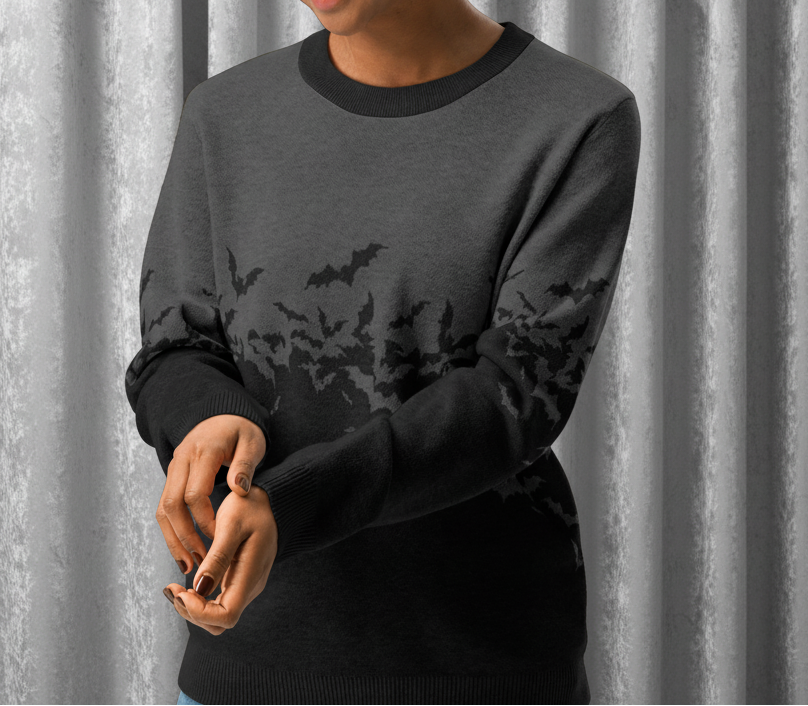 Woman wearing a dark gray sweater with black bat patterns on a transparent background