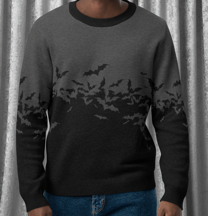 Man wearing a black and gray gradient sweater with bat designs on a transparent background