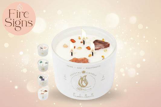 Crystal candle with stones and a flame, labeled 'Fire Signs' by The Mindful Collective.