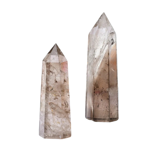 Two crystal towers on a white surface with a blurred background