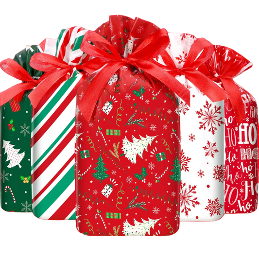 Four Christmas-themed gift bags with ribbons on a white background