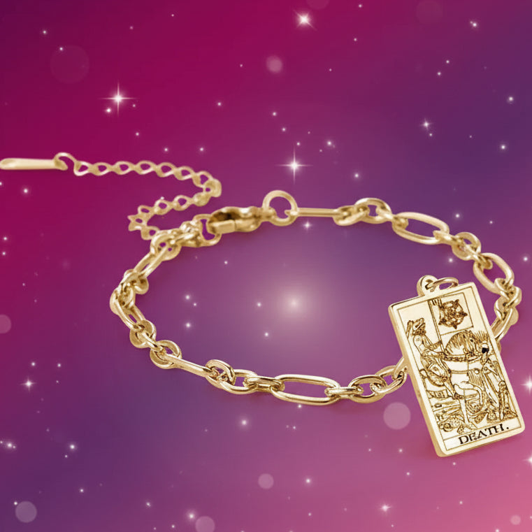 Gold bracelet with tarot card charm on a white background
