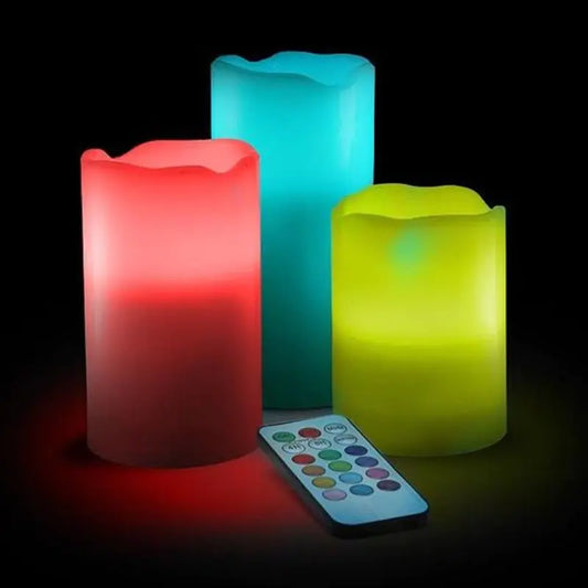 Three colorful LED candles with a remote control on a dark background