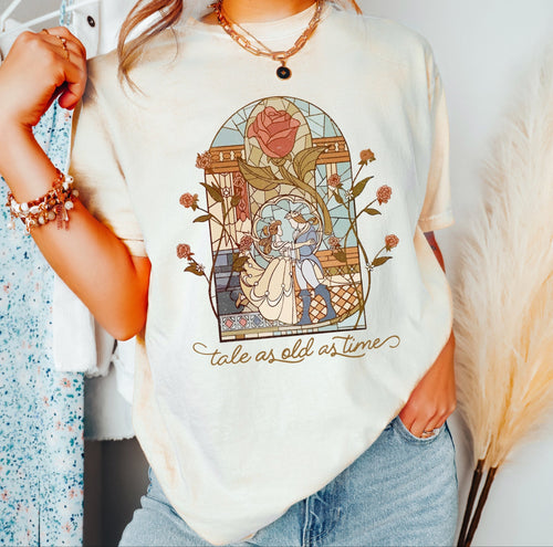 Person wearing a white t-shirt with a graphic design and text, standing against a neutral background.