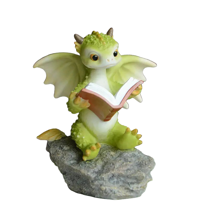 Green dragon figurine reading a book on a rock with a blurred background