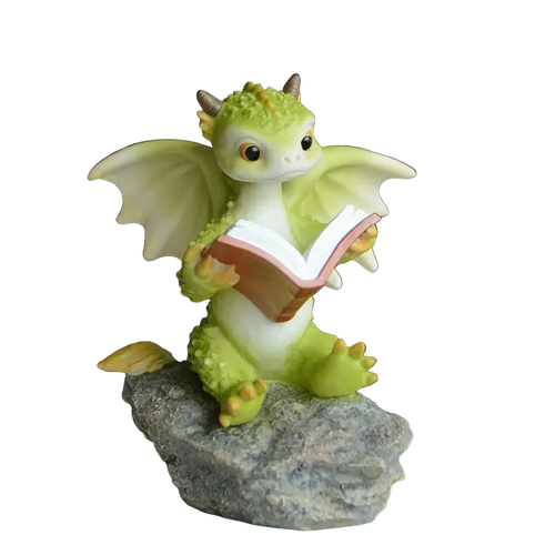 Green dragon figurine reading a book on a rock with a blurred background