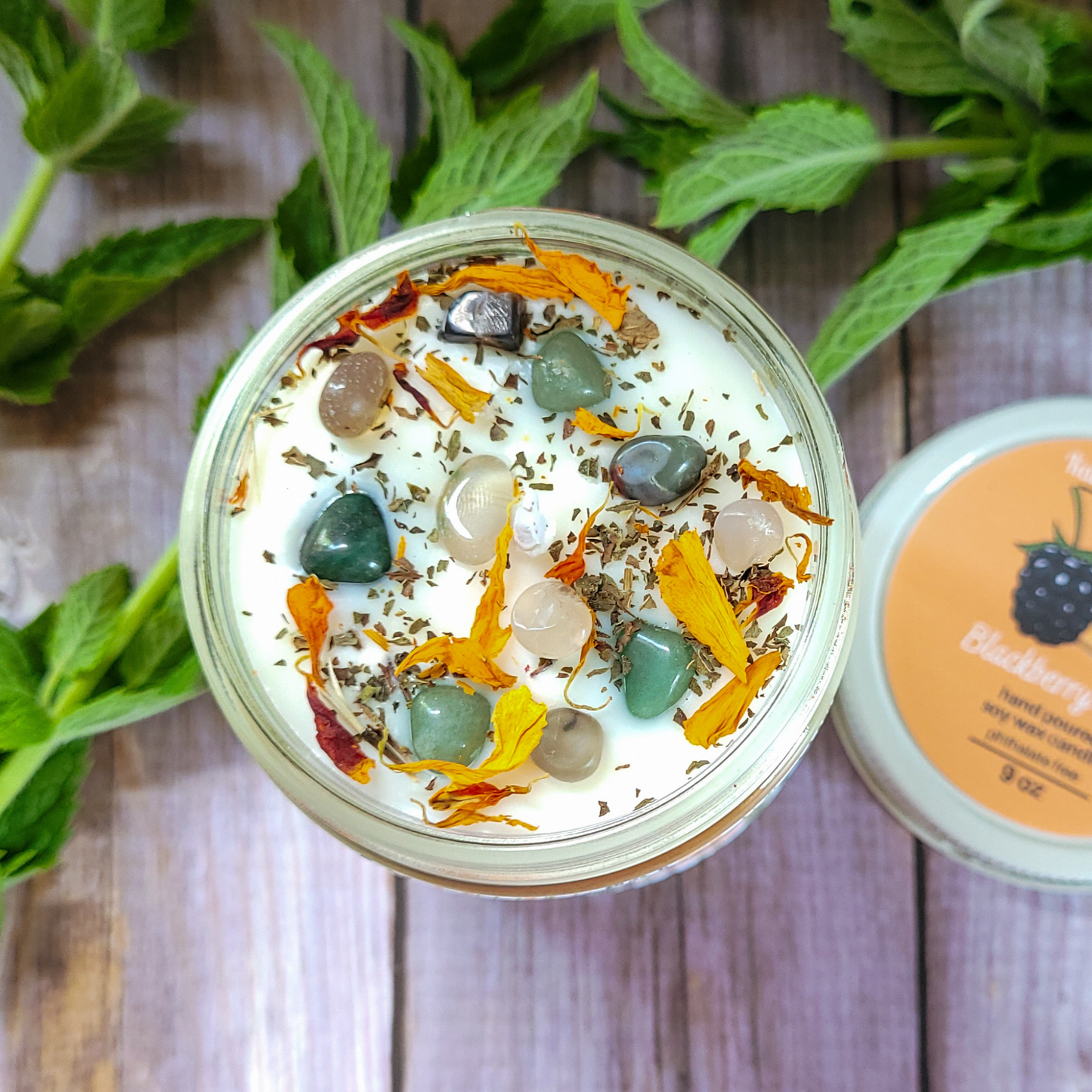 Jar of cream with decorative elements on a wooden surface with mint leaves