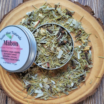 Herbal incense mix in a metal bowl with a label on a wooden surface