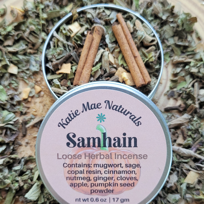 Katie Mae Naturals Samhain loose herbal incense with ingredients listed on a bed of dried herbs.