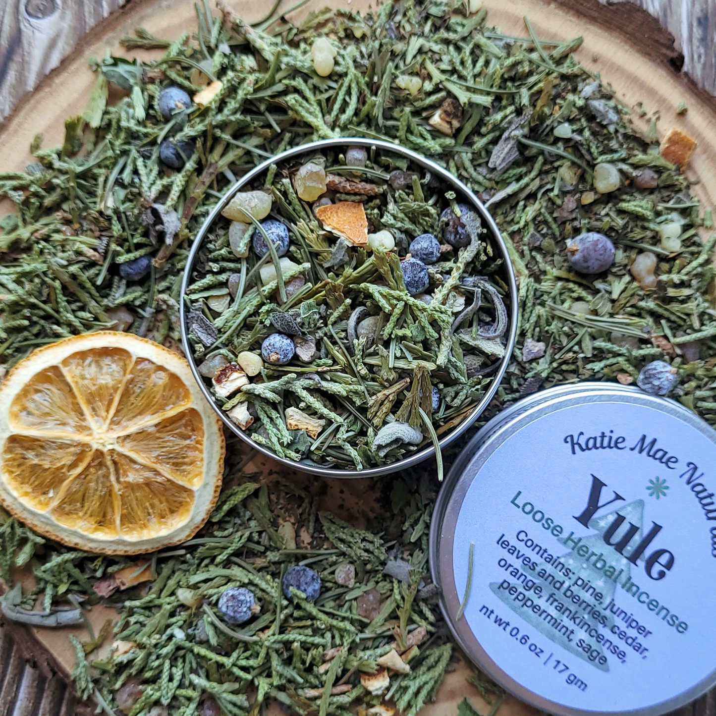 Herbal incense mix with dried orange slice and 'Katie Mae Naturals' Yule label.