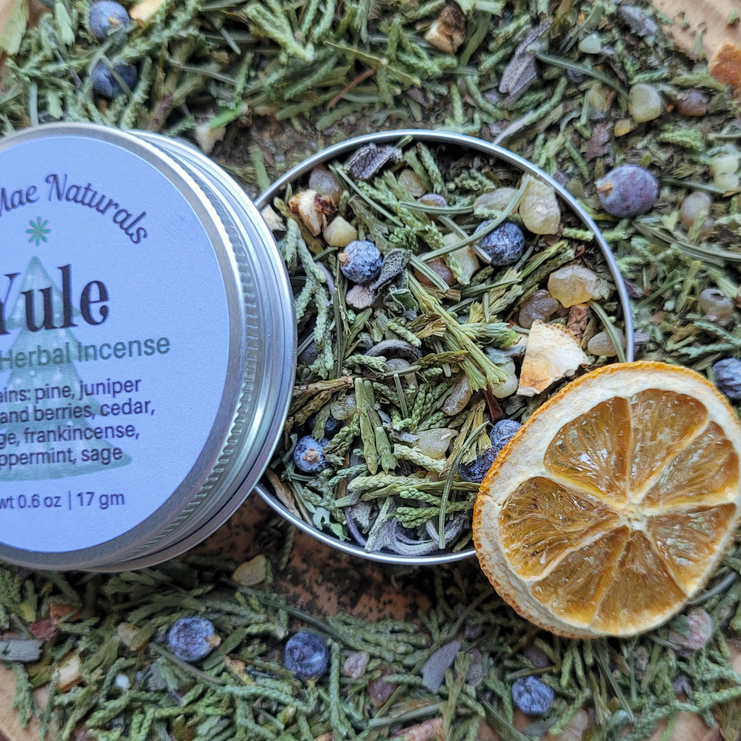 Yule herbal incense with a metal container on a natural background