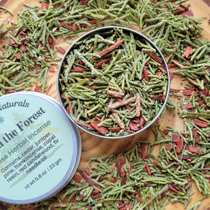 Herbal incense in a metal tin with a label on a wooden surface