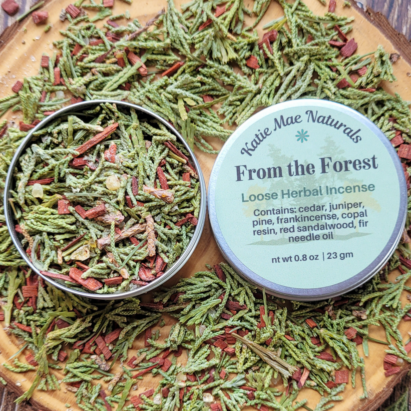 Katie Mae Naturals Loose Herbal Incense on a wooden surface with product packaging.