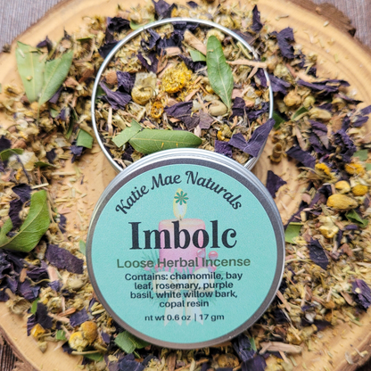 Katie Mae Naturals Imbolc loose herbal incense on a wooden board with dried herbs.