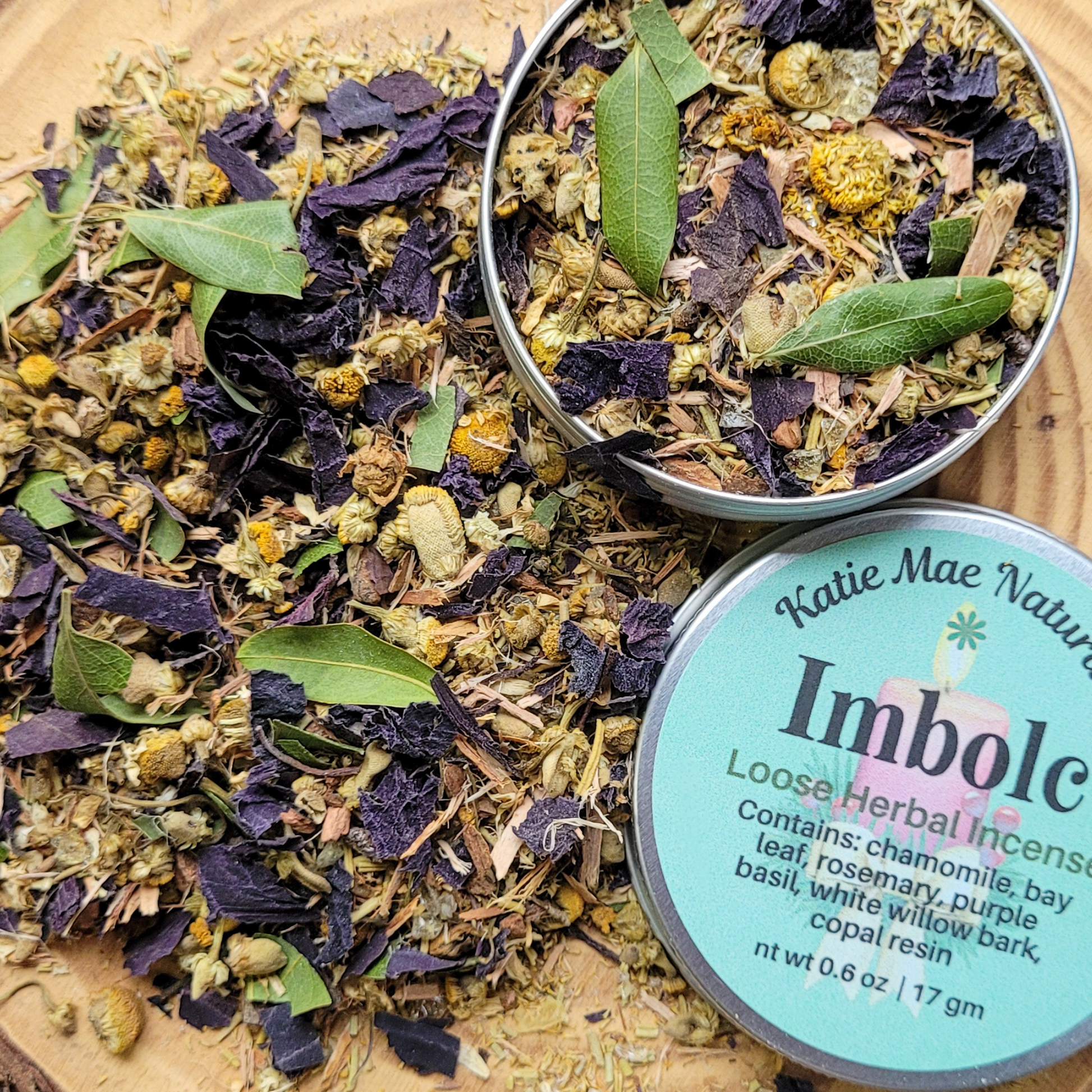Herbal incense mix with 'Katie Mae Naturals' Imbolc label on a wooden surface