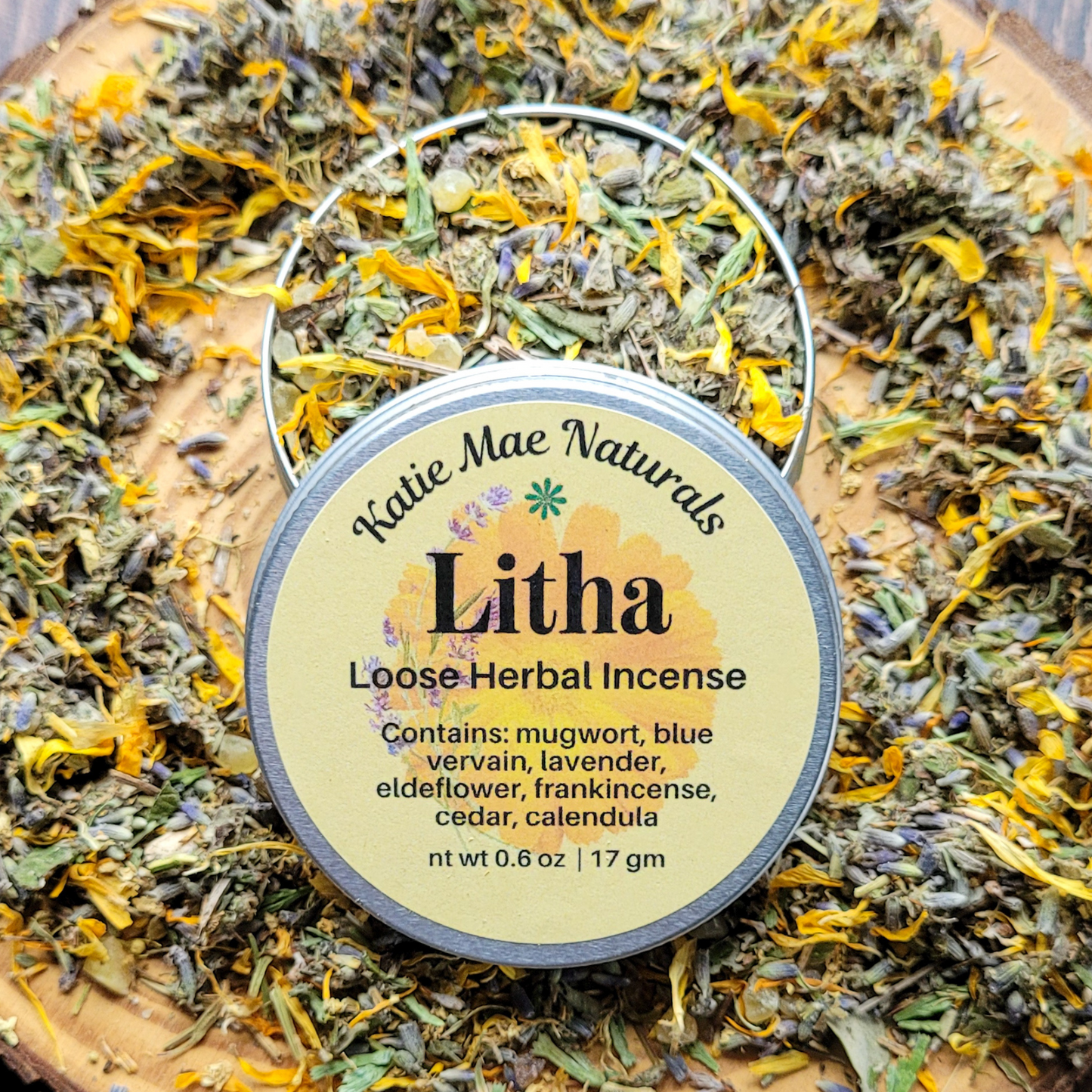 Katie Mae Naturals Litha Loose Herbal Incense container on a bed of dried herbs