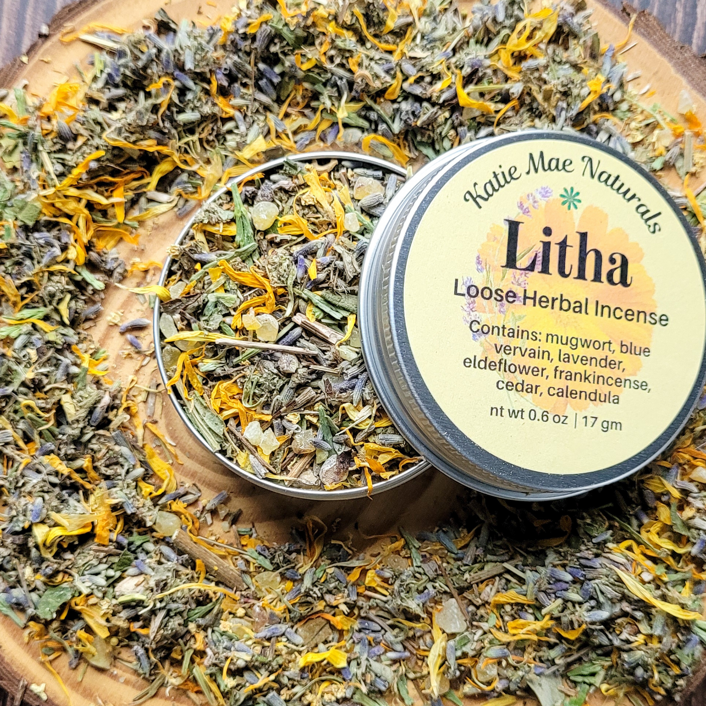 Katie Mae Naturals Litha Loose Herbal Incense on a wooden surface with herbs.