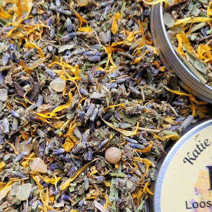 Close-up of dried herbs and flowers with a label reading 'Katie Loos'.