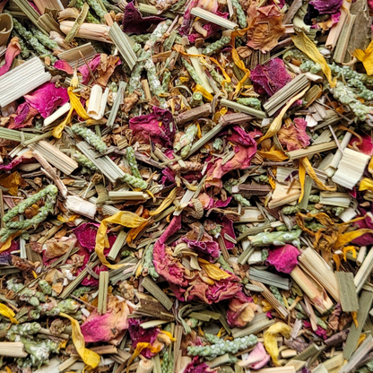 Colorful mix of dried herbs and flowers with pink, green, and yellow hues.