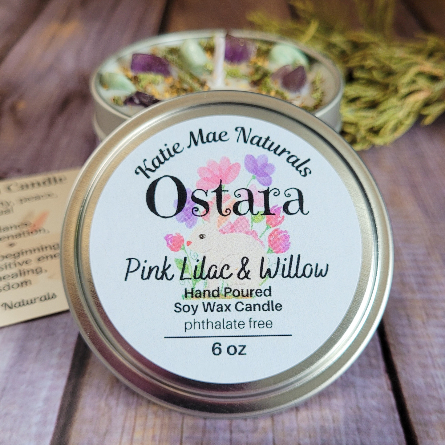 Katie Mae Naturals Ostara Pink Lilac & Willow candle with a wooden background