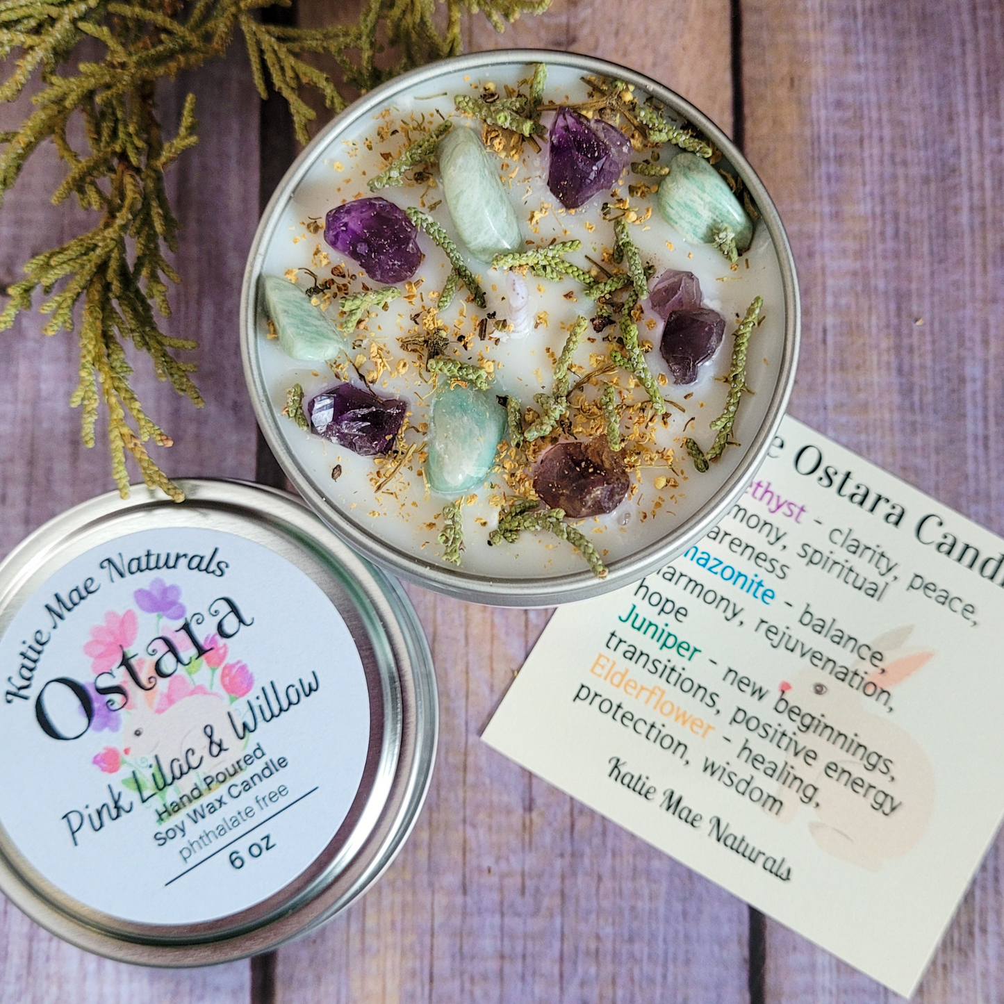 Ostara candle with decorative elements on a wooden surface, accompanied by a label and information card.