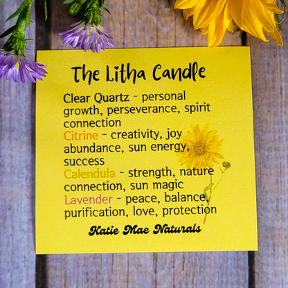 Yellow card with information about 'The Litha Candle' and flowers on a wooden background