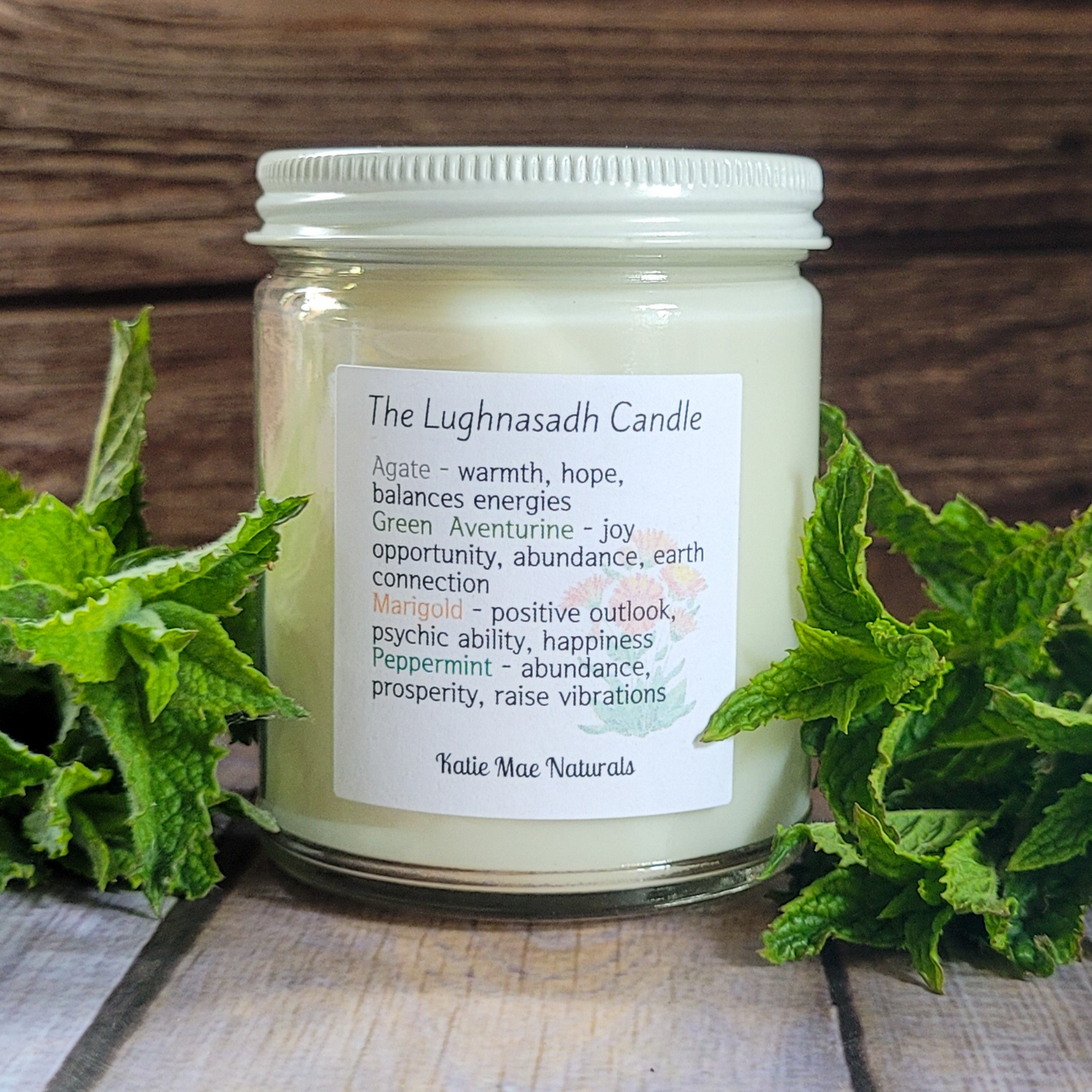 Candle jar with a label on a wooden surface with green leaves