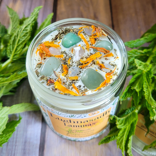 Jar of bath salts with decorative elements on a wooden surface with green leaves.