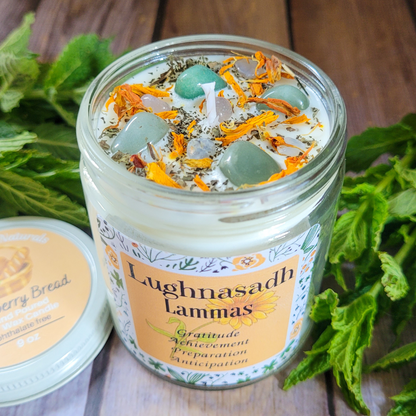 Candle jar with decorative elements and 'Lughnasadh Lammas' label on a wooden surface.