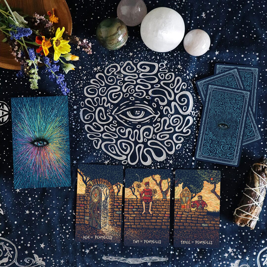 Collection of tarot cards with eye design and natural elements on a starry night background