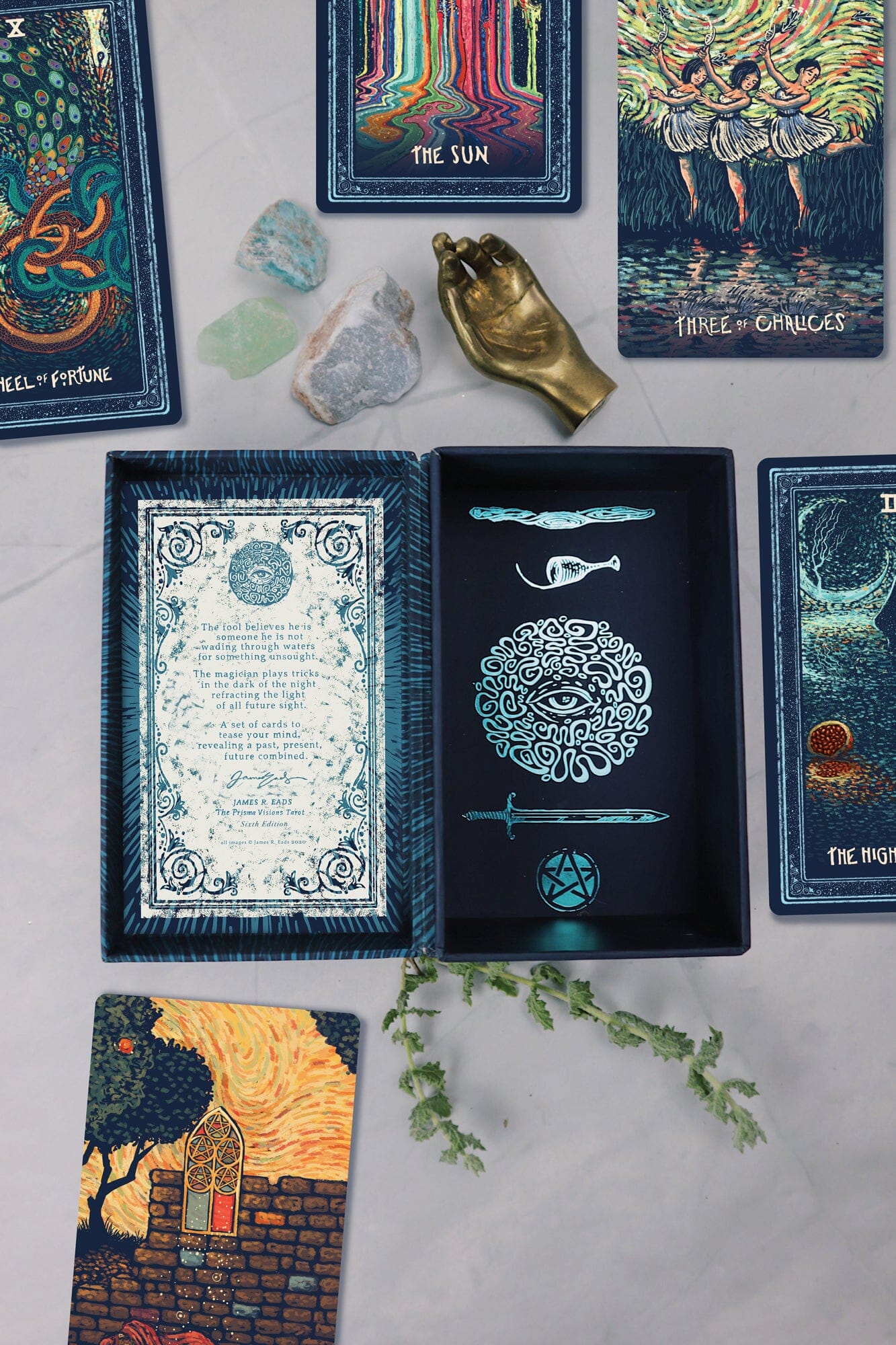 Collection of tarot cards on a flat surface with decorative elements.