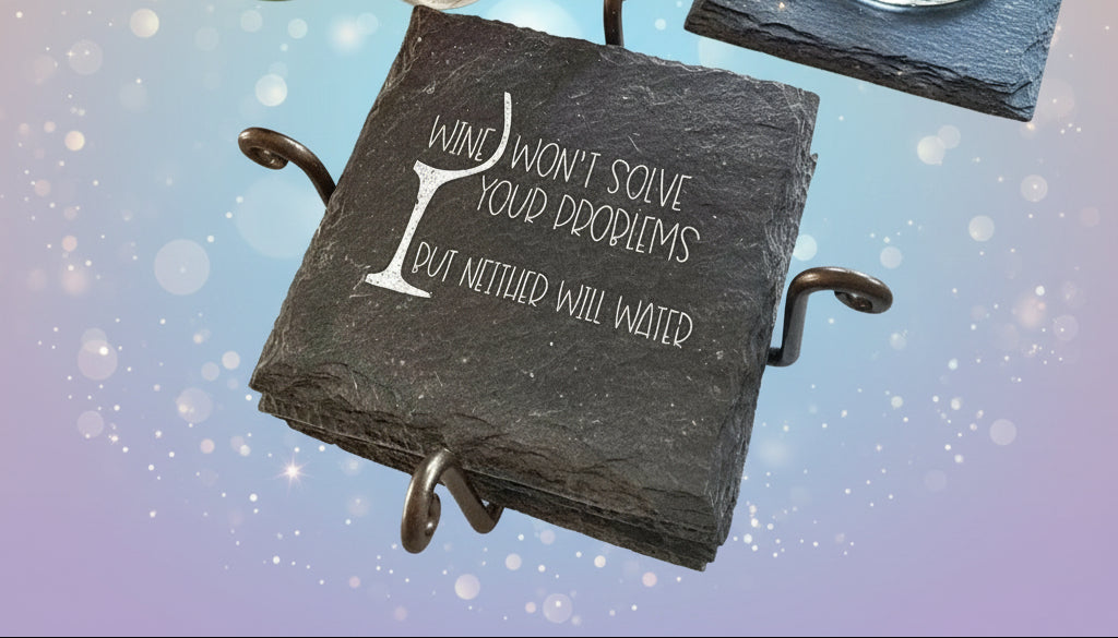 Set of slate coasters with a humorous quote on a textured surface with colorful ornaments.