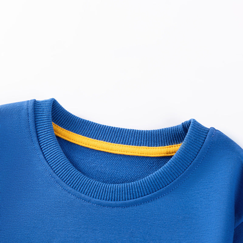 Close-up of a blue sweater with yellow trim on a white background